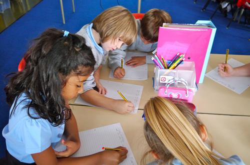 Andrew helps the children write